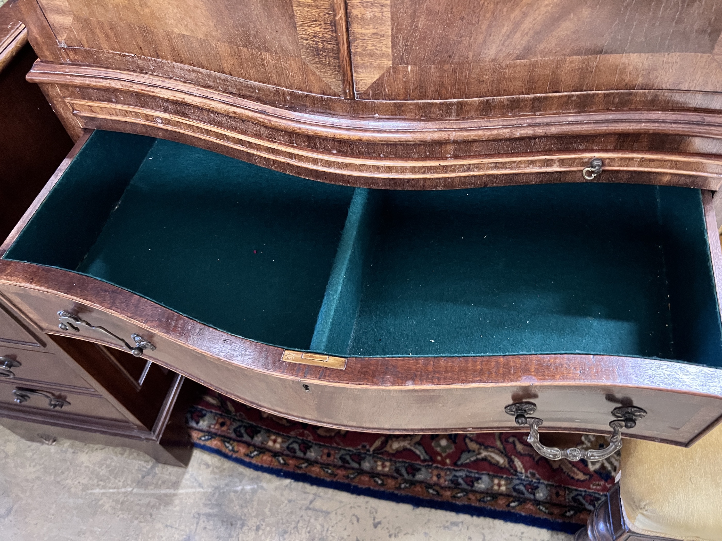 A mahogany serpentine cocktail cabinet fitted with four drawer base, width 73cm